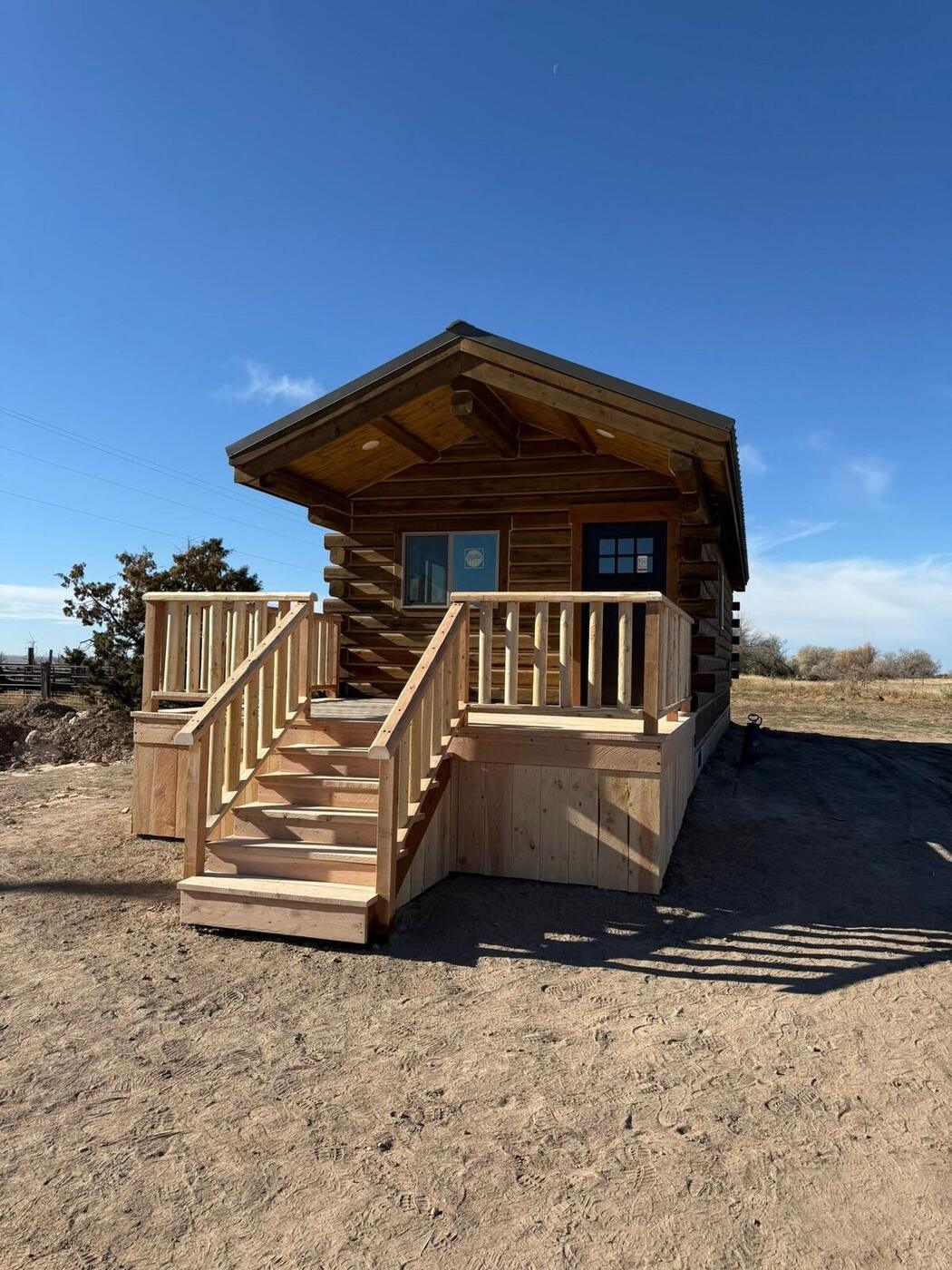 Log cabin with front deck and stairs