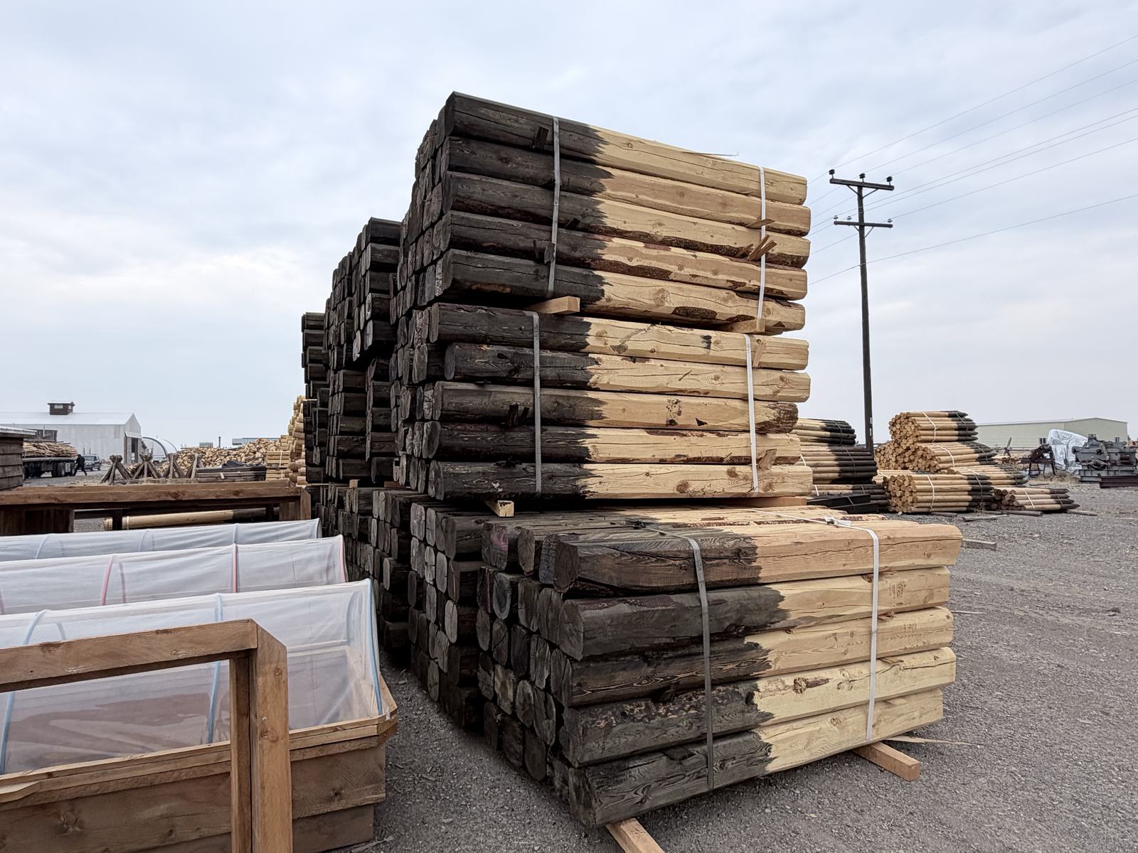 Banded pallets of squared rails and treated posts